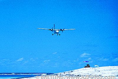 Travel picture with air plane landing at island with travellers. Stock photo from A-Z Fotos.